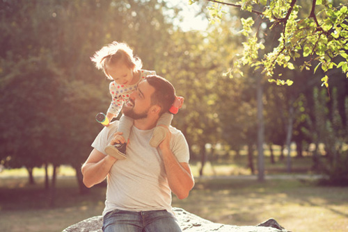 child on dad's shoulders